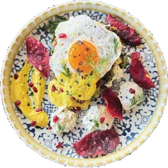 A loaded brunch plate with eggs and greens