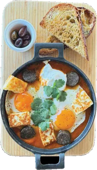 Halloumi shakshuka in a cast-iron pan with sourdough