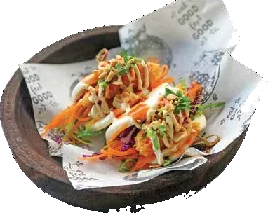 Loaded tacos in a wooden bowl