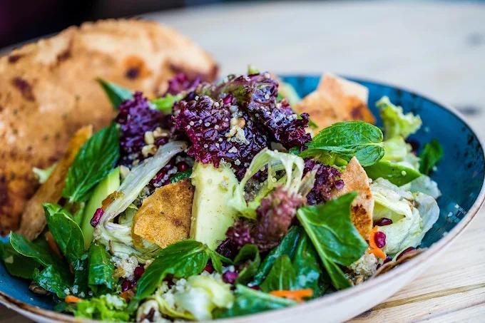 A fresh mixed garden salad with avocado and herbs