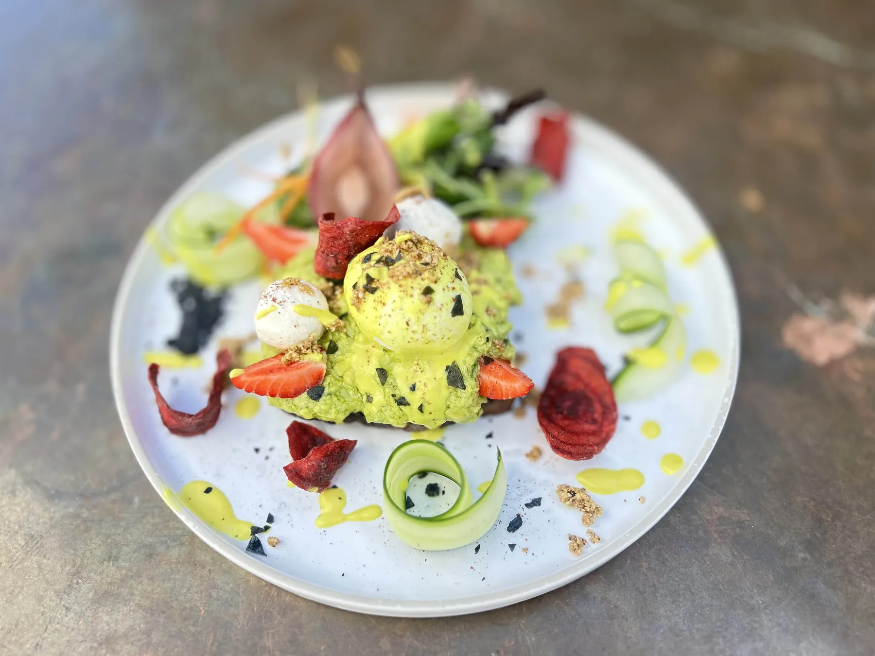 Goat cheese and pear tartine with avocado, strawberries and salad