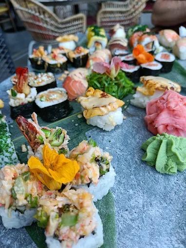 A large assorted sushi platter with wasabi and pickled ginger