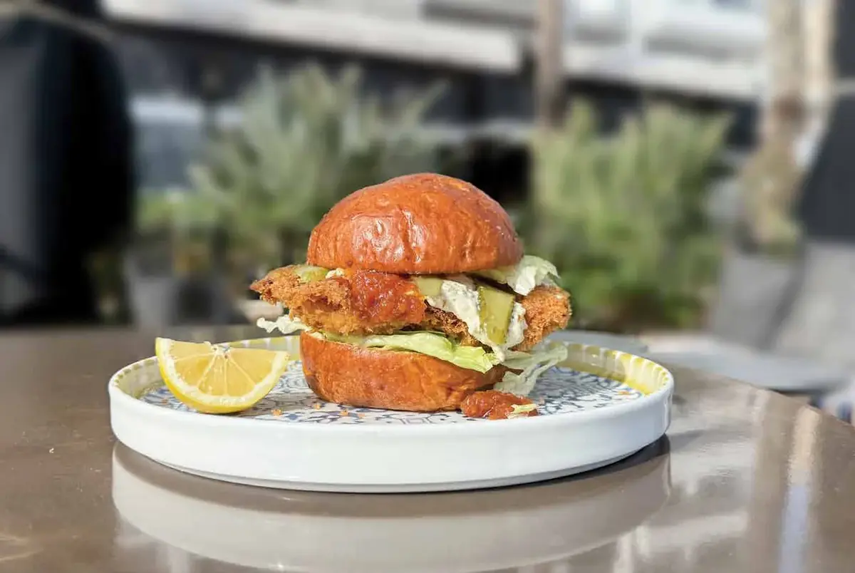 A Brewery burger served on the terrace, with the promenade blurred behind